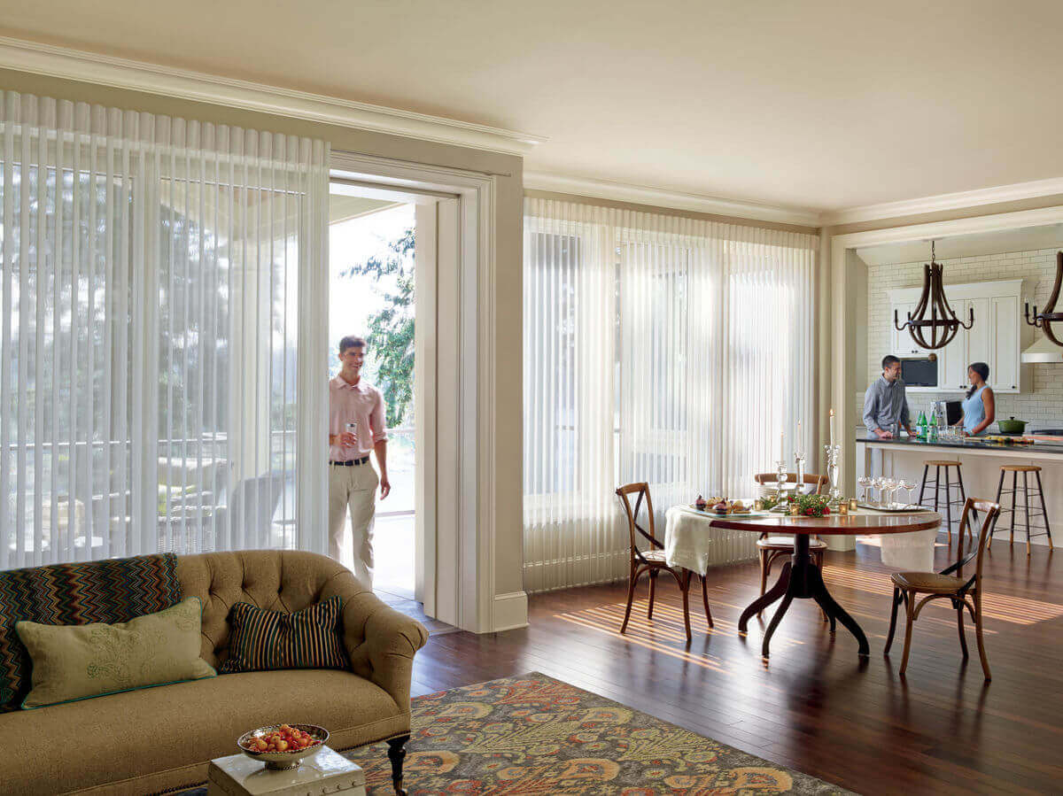 Window treatments designed to operate over sliding glass doors will provide light control and privacy without hindering the use of the doorway. 