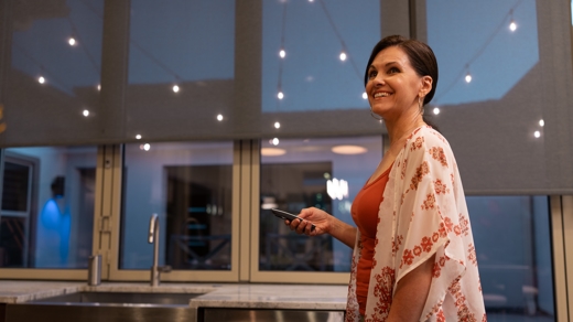 woman holding remote for window coverings