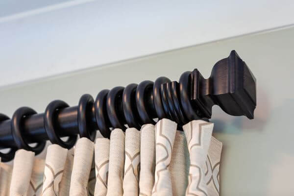 Curtain rings attach the fabric to the curtain rod and allow the treatment to slide open or closed. 