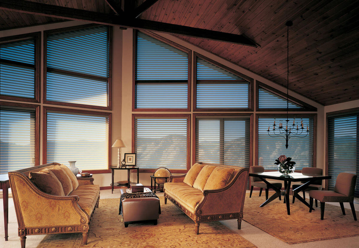 Window treatments for rustic lodge design styles are meant to be functional and fit into the structural design of the space.