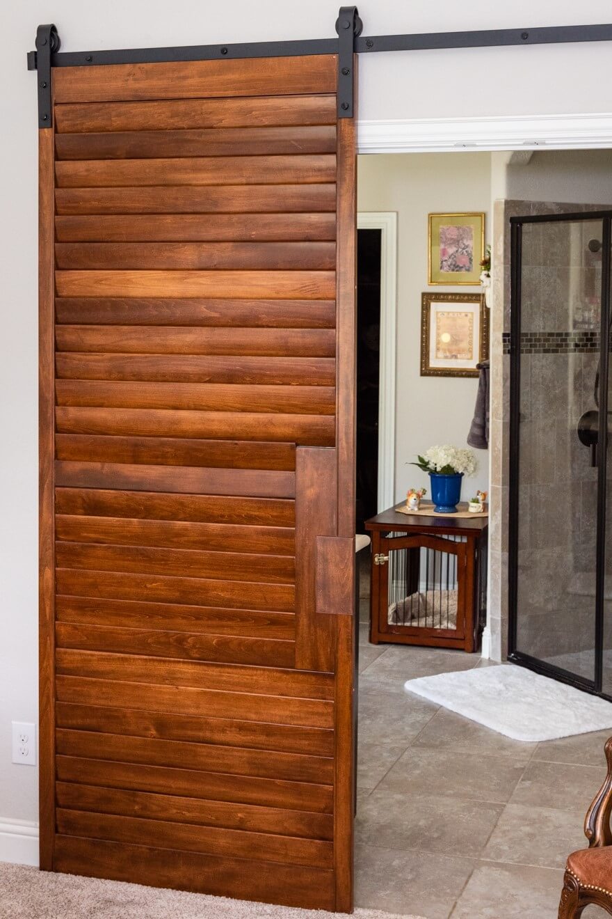 This beautiful sliding barn door is made from old shutters! Utilize old materials to create a new look and stay eco-friendly in your home.