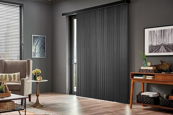 The best window treatment options for sliding glass doors are going to be any styles that hang vertically that can be stacked without taking up too much space, such as vertical blinds, draperies, or sliding panels.