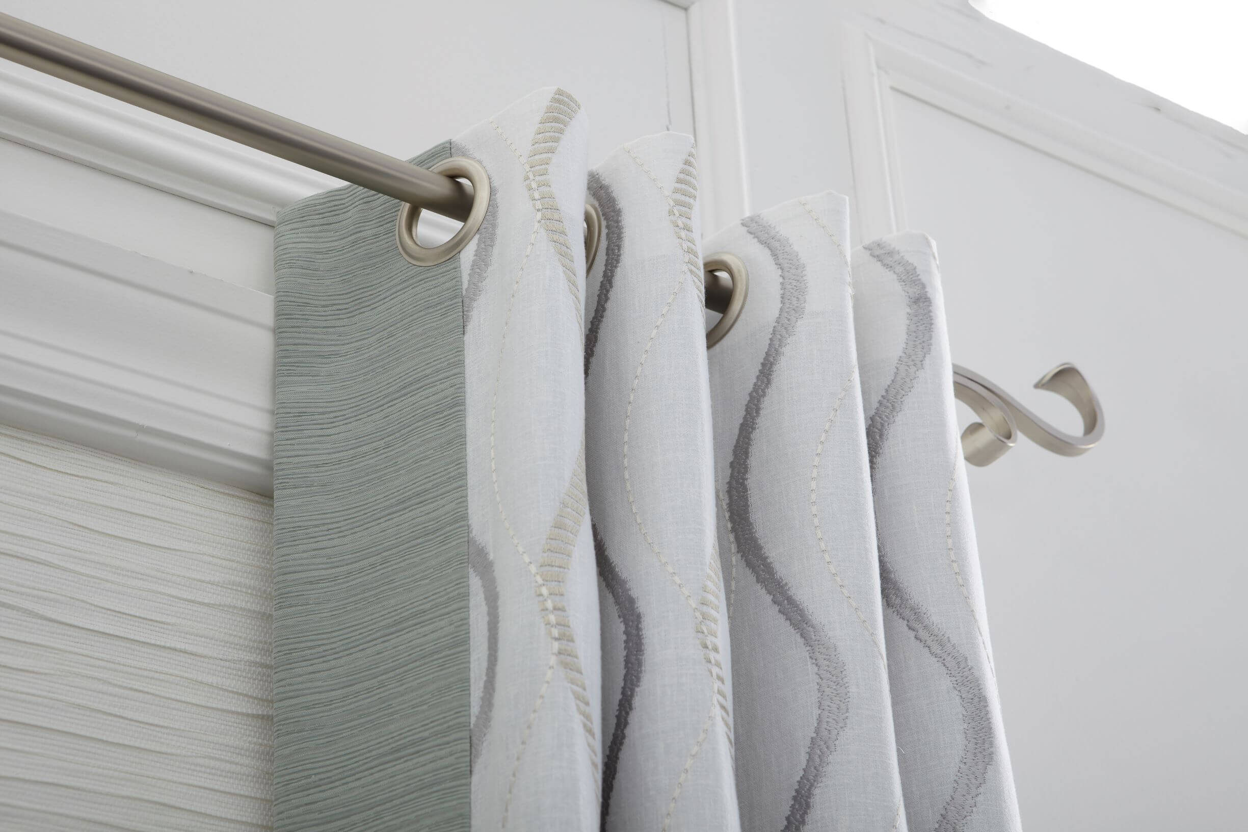Grommet tops are a style of curtain top that have round metal rimmed openings to attach the top portion of the curtain to a rod or pole. Grommet tops are a style of curtain top that have round metal rimmed openings to attach the top portion of the curtain to a rod or pole.