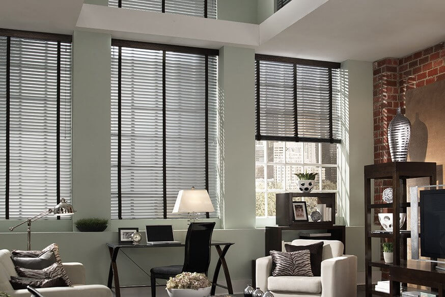 living room with windows covered by black blinds