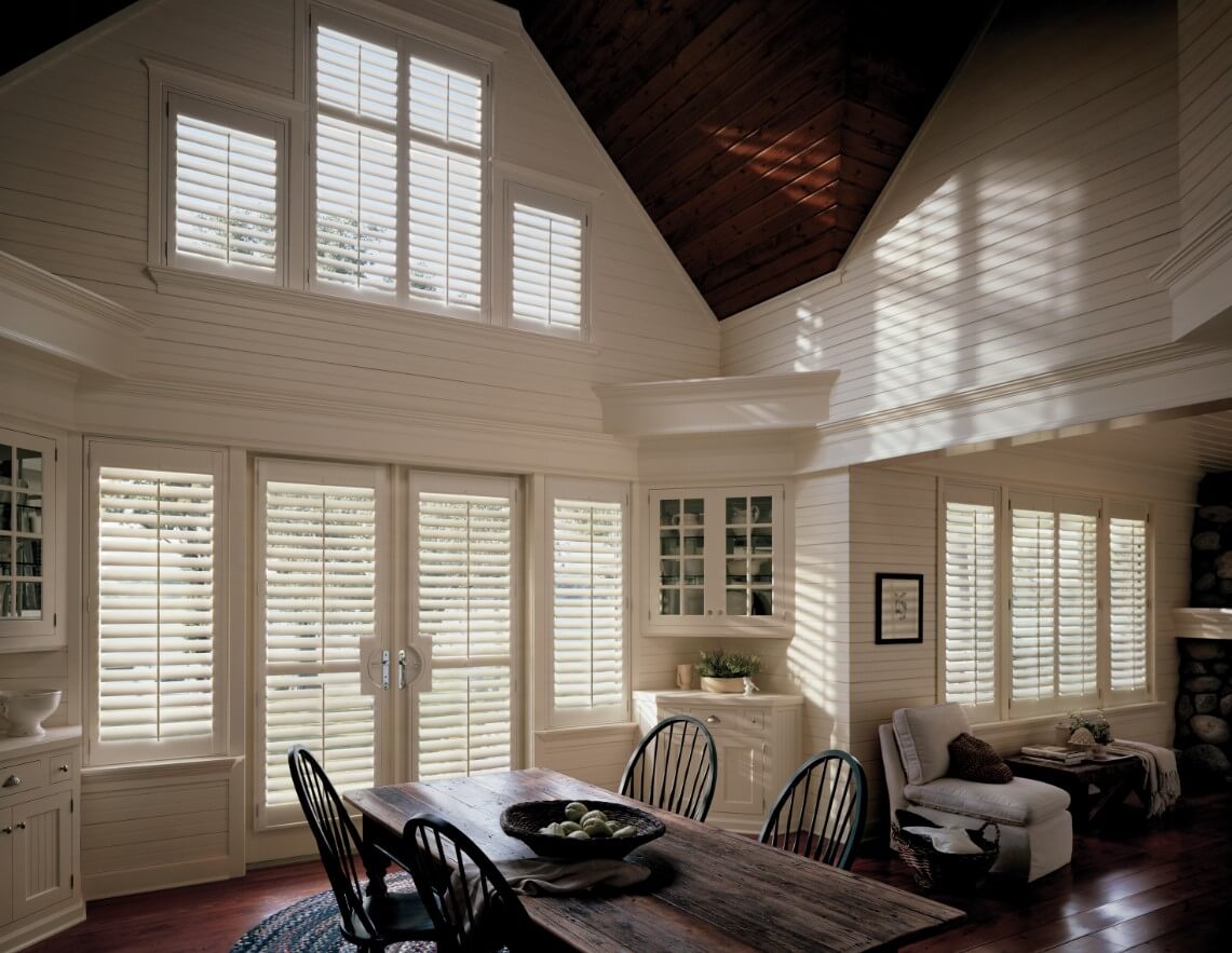 dining space with french doors and windows that have white shutters